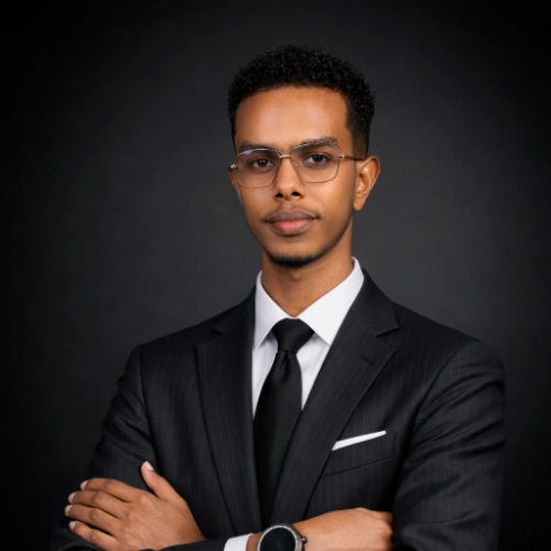 Zakaria Madar wearing glasses and a dark suit